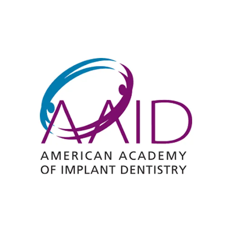 AAID logo featuring blue and purple circular design with stylized tooth symbol and text.