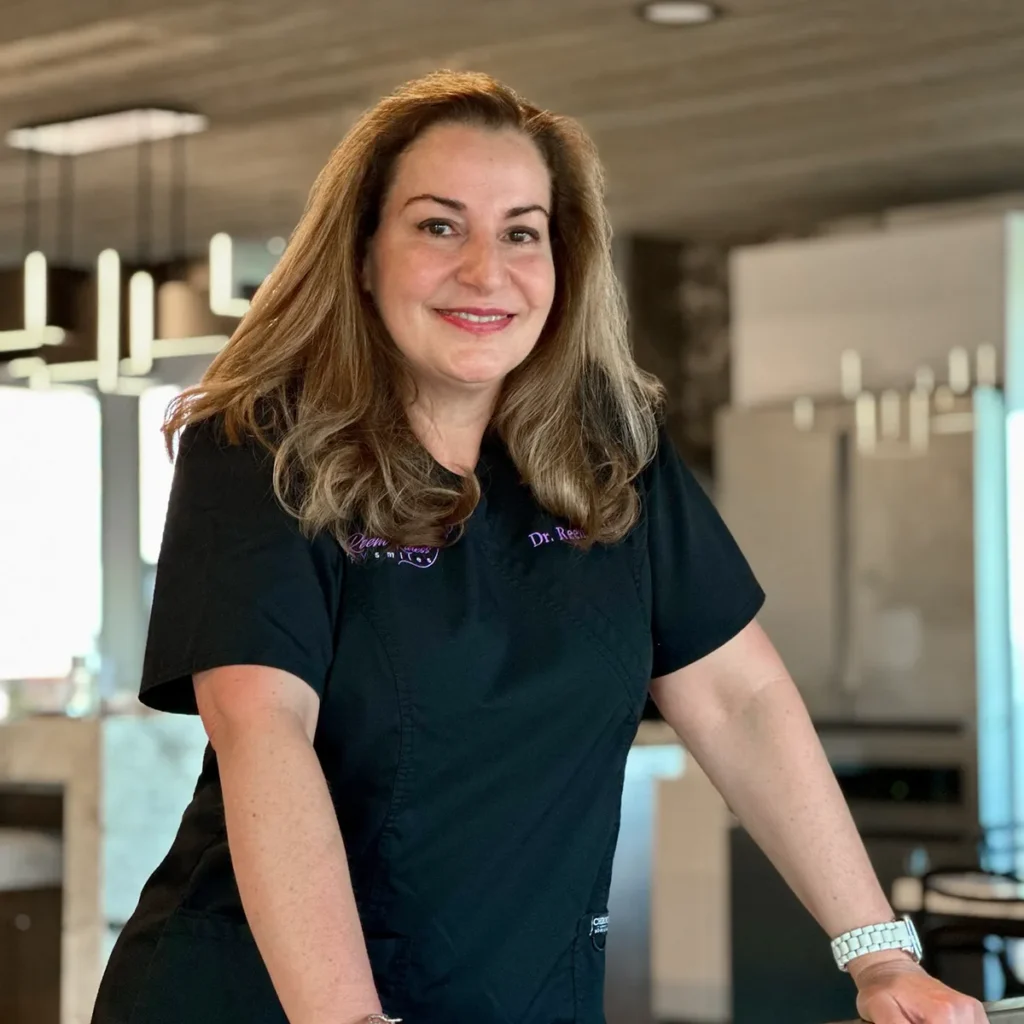 Professional woman smiling in modern office setting wearing black polo shirt