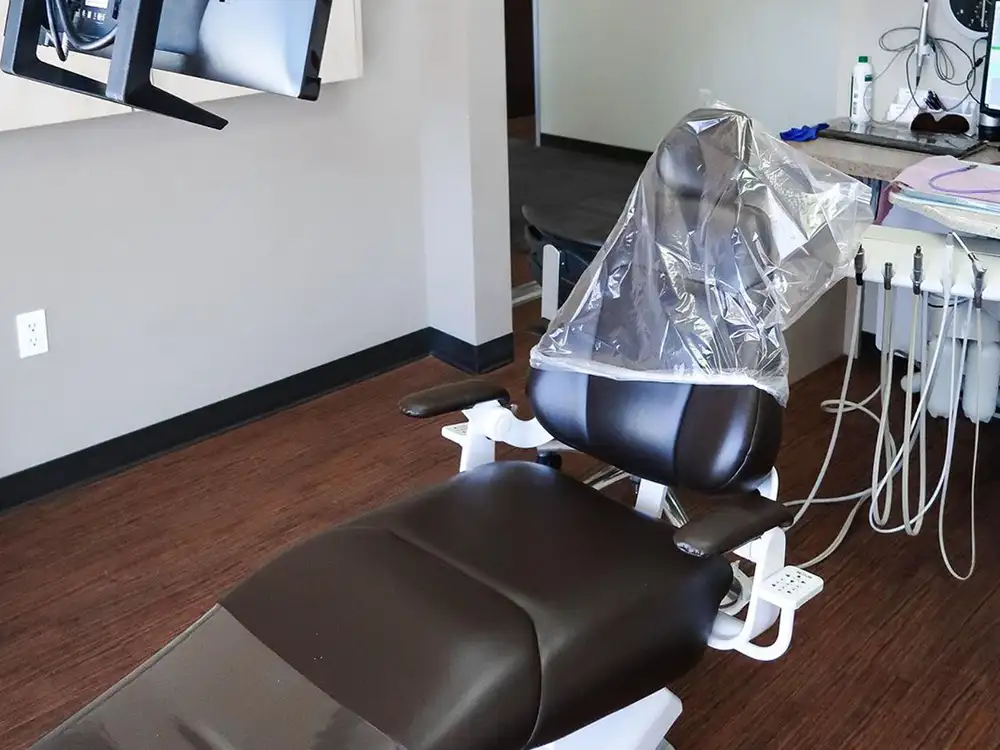 Dental operatory with chair, humidifier, and equipment in modern clinic setting.